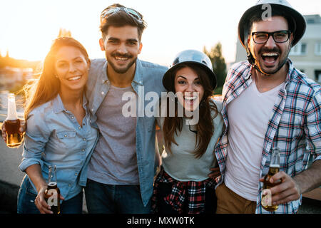 Gruppo di amici felice avente parte sul tetto Foto Stock