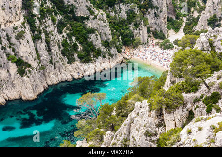 Vista da sopra del di calanque En-Vau, un hard-to-raggiungere stretta insenatura naturale con spiaggia di sabbia bianca vicino a Marsiglia e Cassis, con persone sunb Foto Stock