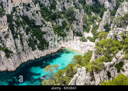 Vista da sopra del di calanque En-Vau, un hard-to-raggiungere stretta insenatura naturale con spiaggia di sabbia bianca vicino a Marsiglia e Cassis, con persone sunb Foto Stock