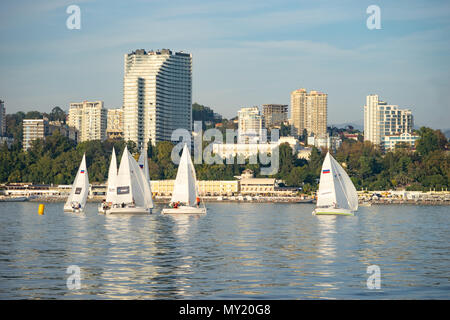 Sochi, Russia-October 8, 2016: regata velica di yacht bianco sullo sfondo della moderna città termale. Foto Stock