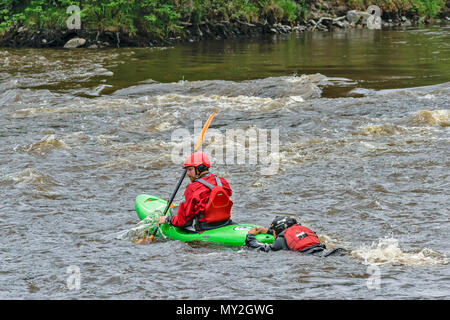 Fiume Spey TAMDHU SCOZIA CANOEIST CANOA KAYAK KAYAK SINGOLA PERSONA CON TRAINO DI UN'ALTRA PERSONA IN ACQUA Foto Stock