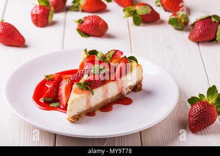 Deliziosa casa cheesecake con fragole bianco su un tavolo di legno. Foto Stock