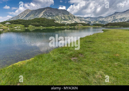 Un fantastico panorama di Todorka picco e riflessione in Muratovo lago, montagna Pirin, Bulgaria Foto Stock