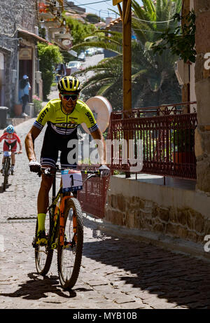 Greco e Turco ciclisti maschio competere in una gara internazionale di mountain bike nel villaggio greco di molivos sull isola di Lesbo Foto Stock