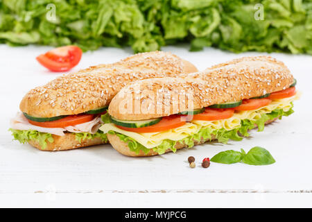 Panini interi grani di grano baguette con prosciutto e formaggio sulla tavola di legno legno Foto Stock