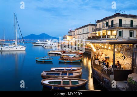 Ristorante La scialuppa e marina accanto al Castel dell Ovo al tramonto con il Vesuvio in lontananza, Napoli, Campania, Italia, Europa Foto Stock