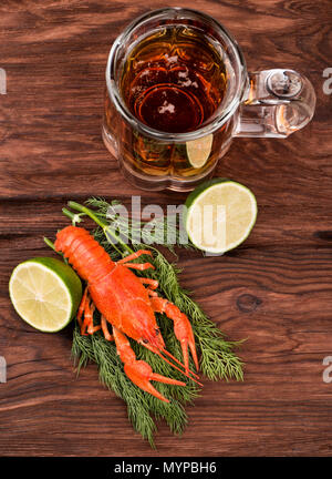 Fresca aragosta bollita con fettine di lime, aneto e bicchiere di birra sul tavolo vista superiore Foto Stock