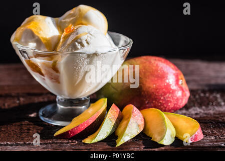 La salsa di caramello gelato e mango fresco frutta Foto Stock