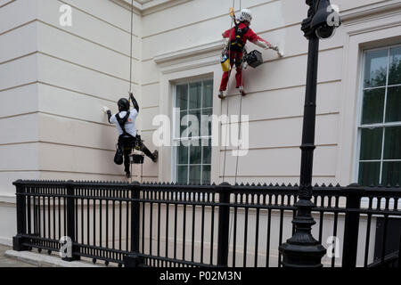 La discesa in corda doppia pittori mettere una nuova mano di colore sulla parte esterna del Laneborough Hotel a Hyde Park Corner, il 8 giugno 2018, a Londra, in Inghilterra. Foto Stock