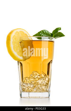 Bicchiere pieno di ghiaccio tè con fette di limone e foglie di tè su sfondo bianco Foto Stock