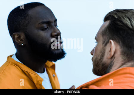 African American prigioniero minacciando cellmate isolato su bianco Foto Stock