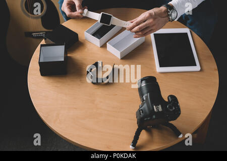 Immagine ritagliata della tecnologia blogger holding nuova smart watch in mani Foto Stock