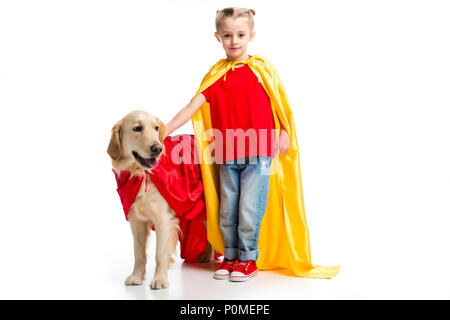 Cane in red cape con supergirl in giallo cape in piedi accanto a isolato su bianco Foto Stock
