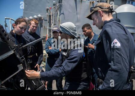 180601-N-GR847-0026 OCEANO PACIFICO (3 giugno 2018) da bombardieri mate 1. Classe Clarence Jones, da San Bernardino, in California, dimostra come utilizzare un 0,50 Caliber machine gun per velisti assegnati a Whidbey Island-class dock landing ship USS Rushmore (LSD 47) durante una formazione composita dell'unità esercizio (COMPTUEX). COMPTUEX è la pre-finale esercizio di distribuzione che certifica il combinato Essex anfibio gruppo pronto e il XIII Marine Expeditionary Unit la capacità di condurre operazioni militari in mare e proiettare potenza a terra durante la loro prossima distribuzione nell estate del 2018. (U.S. Foto di Marina di Massa Comm Foto Stock