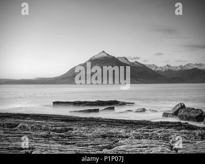 La famosa Baia rocciosa di Elgol sull'Isola di Skye in Scozia. Il Cuillins mountain in background. Fotografato al tramonto. Foto Stock