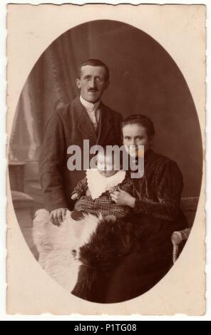 PRAHA (Praga), la Repubblica cecoslovacca - circa 1923: Vintage mostra fotografica di famiglia - il padre, la madre e il bambino. Retrò in bianco e nero studio fotografico di una famiglia borghese. Foto Stock