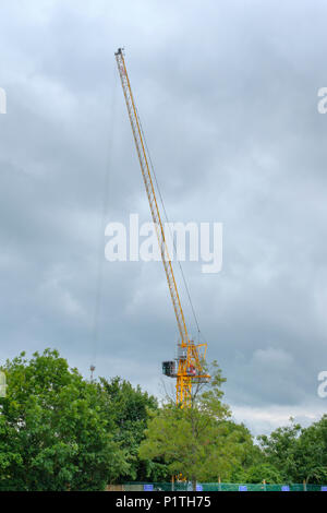 Yellow Crane lavorando su un nuovo sviluppo a Oakham Rutland, contro oscura pioggia nuvole. Regno Unito Foto Stock