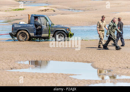 Appledore, North Devon, Regno Unito. Xiv Jun, 2018. Con la bassa marea Royal Marines in base a Instow aiutare la comunità locale mediante il recupero di un veicolo 4x4 che è incagliata nel fiume Torridge estuary oltre una settimana fa. Grandi folle sono state disegnate in banchina a Appledore ed acclamato come il veicolo è stata trasportata a terra questo pomeriggio. Credito: Terry Mathews/Alamy Live News Foto Stock