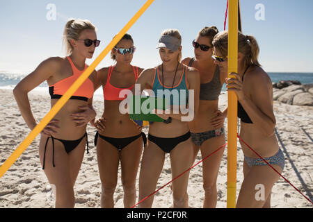 Pallavolo femminile coach interagendo con i giocatori di sesso femminile Foto Stock