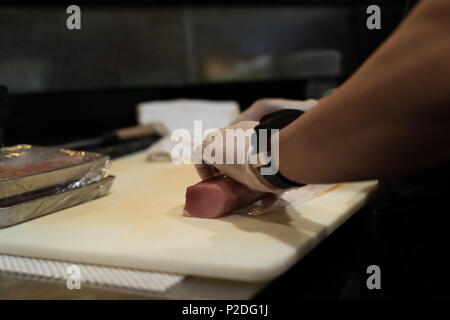 Lo Chef tenendo il pesce rotolo di carne Foto Stock