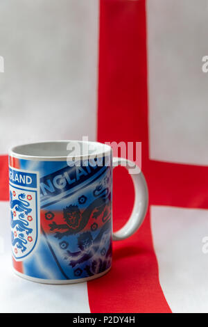 14 Giugno 2018 - Bere mug recanti i tre leoni badge seduto su una bandiera inglese prima del 2018 FIFA World Cup International Football Tournamen Foto Stock