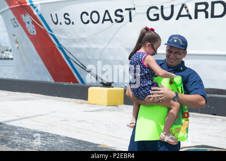 Coast Guard Petty Officer 2a classe Roberto Iaboni, un membro di equipaggio a bordo del guardacoste Venturous, riunisce con sua figlia, Kaydee Iaboni, dopo il ritorno a casa a San Pietroburgo, Florida, lunedì, Sett. 12, 2016. La taglierina restituito dopo 8 settimana interagenzie comune compito Force-South pattugliamento nell'Oceano Pacifico orientale. (U.S. Coast Guard foto di Sottufficiali di seconda classe Ashley J. Johnson) Foto Stock