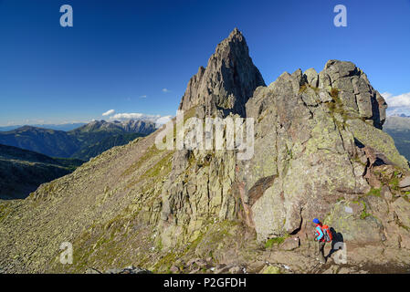 Donna discesa dalla Forcella Valon con Latemar gamma in background, Trans-Lagorai, Lagorai, Dolomiti, patrimonio mondiale il suo Foto Stock