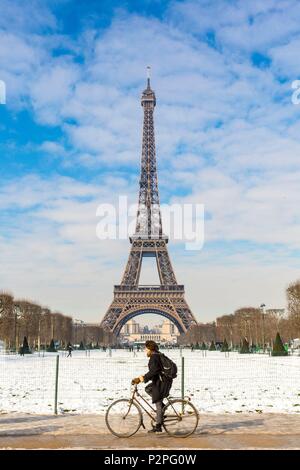 Francia, Parigi, zona elencata come patrimonio mondiale dall' UNESCO, gli Champs de Mars, un ciclista davanti alla Torre Eiffel, nevicate su 07/02/2018 Foto Stock