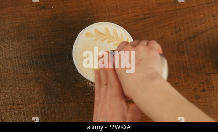 Barista preparare cappuccinno latte art caffè in tazza bianca Foto Stock