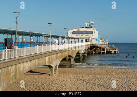 Il molo di Bournemouth e la spiaggia con un cielo blu chiaro Foto Stock