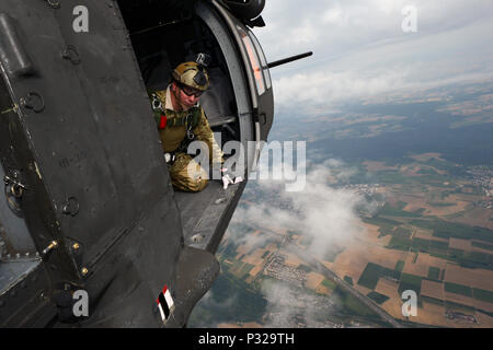 Stati Uniti Airman Senior Sergente Dean L. Unger, assegnato per il Comando Operazioni Speciali Europa, osserva le condizioni di vento durante un volo di formazione le operazioni di esercizio in cui i partecipanti hanno saltato fuori degli STATI UNITI Esercito Sikorsky UH-60 Black Hawk elicotteri da 12.000 piedi sopra il Malmsheim Drop Zone di Stoccarda, Germania, e il agosto 18, 2016. (U.S. Esercito foto di Visual Information Specialist Jason Johnston/rilasciato) Foto Stock