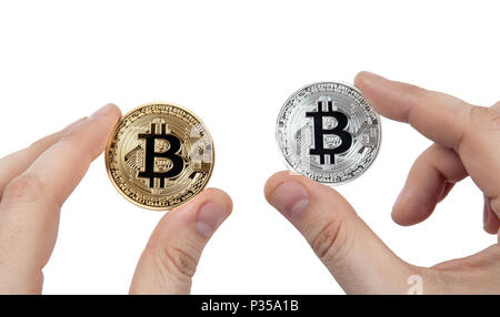 Due monete di bitcoin nelle mani di un uomo su sfondo bianco Foto Stock