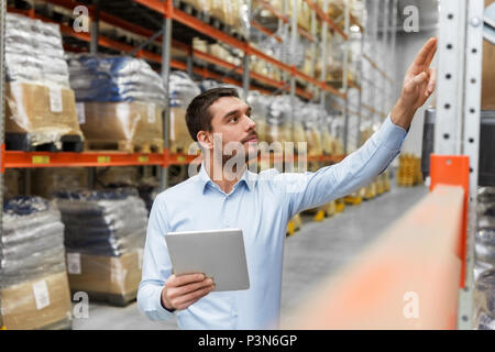 Imprenditore con tablet pc al magazzino Foto Stock