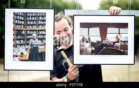 Hannover, Germania. 19 giugno 2018. Studente Ilkay imposta foto della relazione 'Dcome Herz im Harz' da Vivian Rutsch, in corrispondenza della zona esterna della Lumix festival per giovani fotogiornalismo. Il giornalismo fotografico e documentario photorgaphy corsi di studio dell'Hochschule Hannover (Università di scienze applicate e le arti) trasforma l'ex-Expo motivi in una grande mostra fotografica. I visitatori possono guardare avanti a 60 coperture con più di 1400 immagini. Credito: Hauke-Christian Dittrich/dpa/Alamy Live News Foto Stock