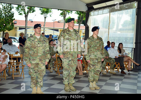 Col. Steven M. Marchi, centro, il comandante del presidio di Italia, comandante uscente Capt. Harrison M. Zabell, sinistra e comandante in arrivo Capt. Brenna T. Roorda, diritto, società Garrison Italia, stand presso l'attenzione, 29 giugno 2016, durante il cambiamento di cerimonia di comando per gli Stati Uniti Army Garrison Italia sede e Sede Società presso Caserma Ederle a Vicenza, Italia. (U.S. Esercito foto di Visual Information Specialist Antonio Bedin/rilasciato) Foto Stock