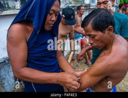 Filippino uomini hanno colpito themselve il Venerdì Santo al cimitero di Gasan, Marinduque Island, Filippine Foto Stock