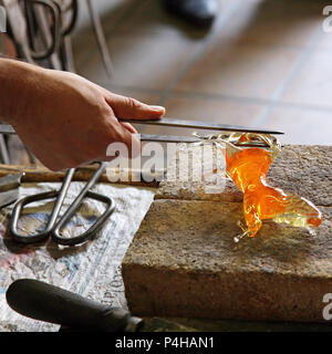 Artista di vetro nella sua officina rendendo glasswareVenice Foto Stock