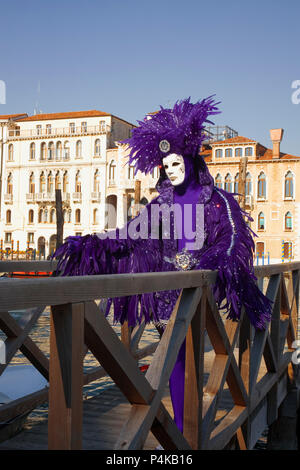 Campo della Salute, Dorsoduro, Venezia, Italia: reveller mascherato che indossa un costume sfumato pone dal Canal Grande Foto Stock