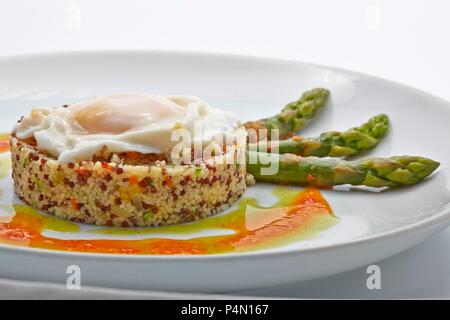 La quinoa timballo con uovo fritto e asparagi verdi Foto Stock