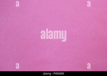 La coperta di pelliccia rosa in tessuto di pile. Una texture di sfondo di luce rosa peluche morbido materiale in vello . Foto Stock