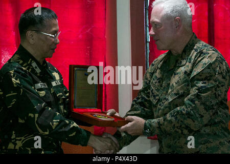 Le forze armate delle Filippine Brig. Gen. Tirso Dolina, capo cappellano, presenta un premio negli Stati Uniti. Navy Capt. Contrassegnare Hendricks, cappellano con U.S. Marine Corps forze, pacifico, durante un incontro a sostegno di Balikatan 2017 a Camp Aguinaldo, Quezon City, 8 maggio 2017. Balikatan è un annuale U.S.-Philippine bilaterale di esercitazione militare incentrato su una varietà di missioni, comprese la fornitura di assistenza umanitaria e di soccorso in caso di catastrofe, la lotta contro il terrorismo e altri combinati di operazioni militari. Foto Stock