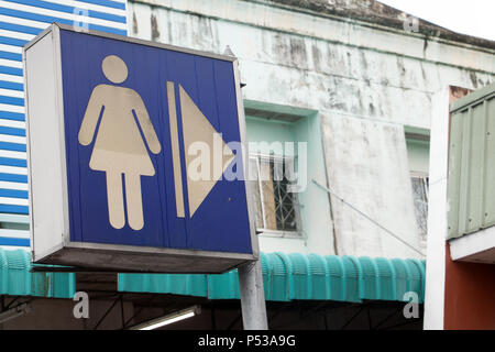 Una scheda grafica con una figura femminile icona mostra la direzione della strada per la toilette delle donne. Foto Stock