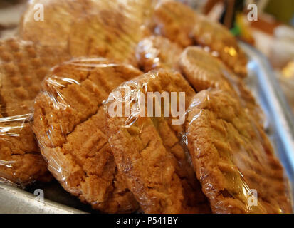 Appena sfornato il burro di arachidi cookies in involucro di plastica in una panetteria coffeehouse contatore. Foto Stock