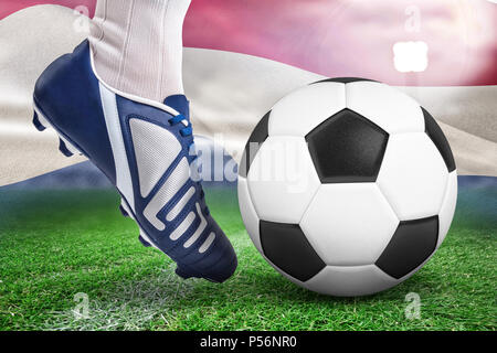 Immagine composita della chiusura del giocatore di football dando dei calci a sfera Foto Stock