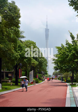 Guangzhou - Cina - Giugno 09, 2018; persone passeggiando nei giardini vicino alla Torre del cantone in un giorno di tempesta in Guangzhou New Town. Foto Stock