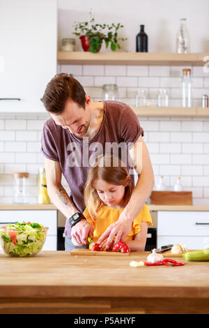 Foto del padre con la figlia piccola insalata di cottura Foto Stock