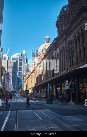 Una vista di George Street con il sole che splende sulla Queen Victoria Building e alti edifici di nuova parte di Sydney in background Foto Stock