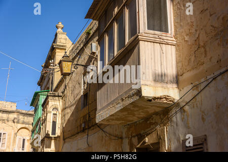 Balconi in legno su case tradizionali in freccia vicoli di Victoria Città Vecchia, Gozo, Malta. Foto Stock