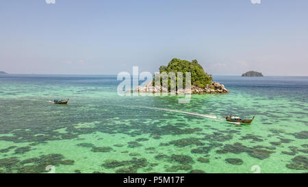 Vista aerea dall'alto dell'isola tropicale rocciosa con le barche bangka nelle acque cristalline della barriera corallina turchese di Siargao, Filippine Foto Stock