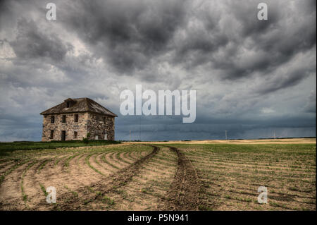 Prairie nuvole temporalesche Canada Saskatchewan edifici abbandonati Foto Stock